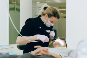 A man receiving treatment from a dentist.