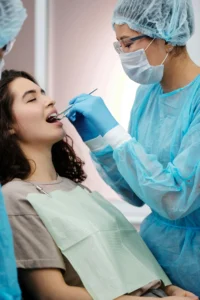 A woman receiving treatment from a dentist.