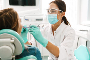 A woman receiving treatment from a dentist.