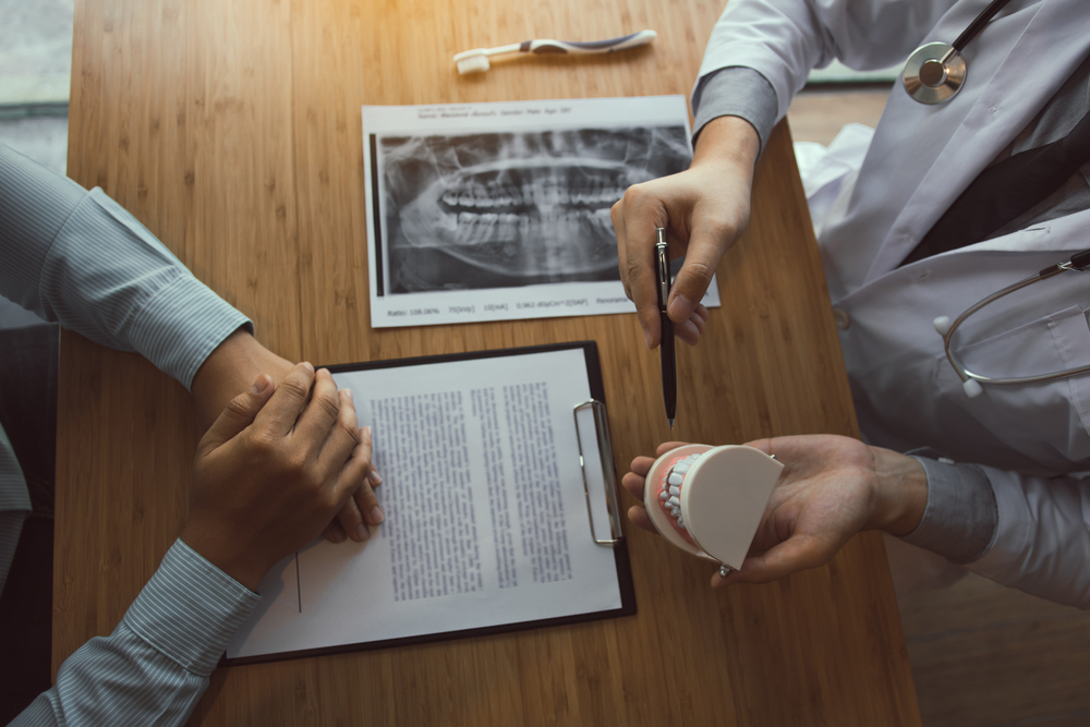 A patient receiving a consultation from an expert in dental care.