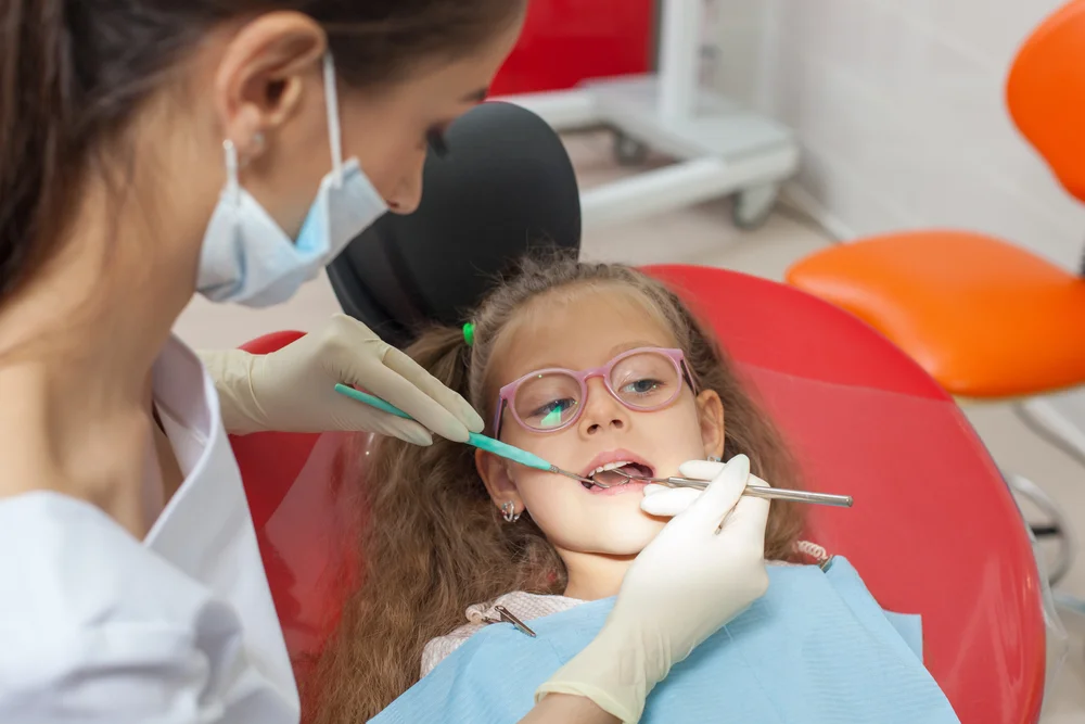 A young girl receiving dental treatment.